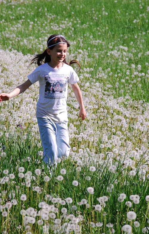 女孩站在白色的花瓣上花 · 免费素材图片