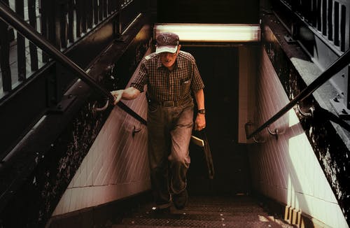 衣领衬衫和灰色的裤子，在楼梯上行走的人 · 免费素材图片