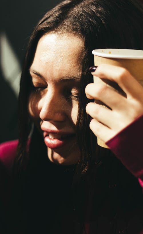 女人穿着红色的长袖衬衫，拿着杯子 · 免费素材图片