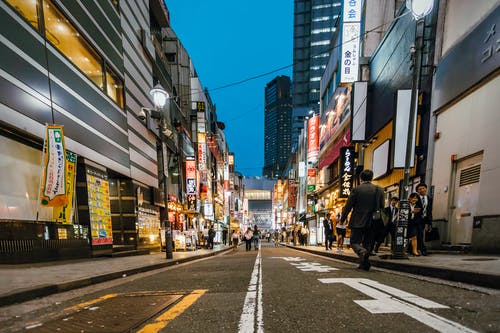 在高层建筑之间行走的人 · 免费素材图片