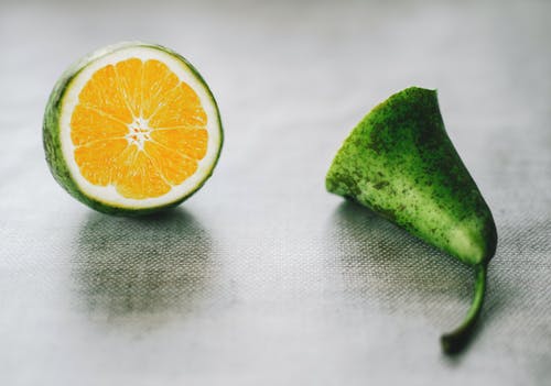 灰色表面上的绿色柑橘类水果 · 免费素材图片