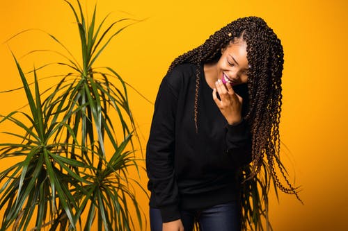 乐观年轻黑人女性在黄色工作室开心 · 免费素材图片