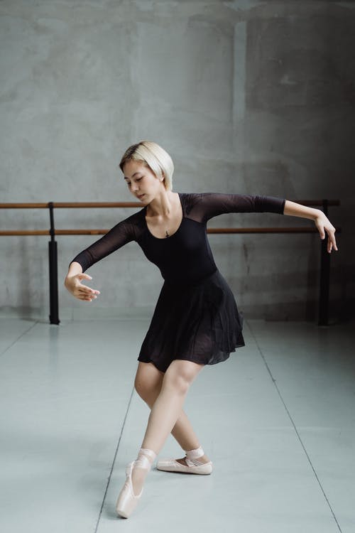 有才华的芭蕾舞演员在灯光工作室中跳舞芭蕾舞 · 免费素材图片