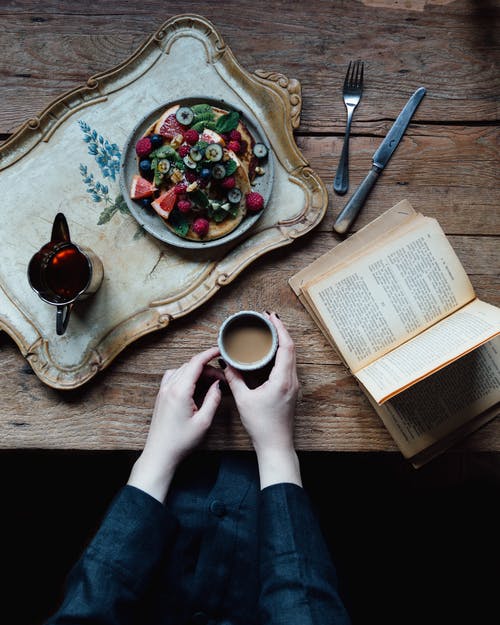 作物与书和早餐的女人 · 免费素材图片