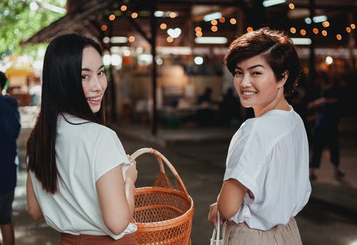 亚洲美女与柳条篮子在步行街上行走 · 免费素材图片