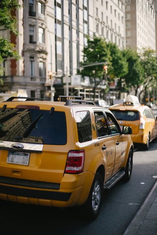 在阳光下的街道上的黄色跨界出租车 · 免费素材图片