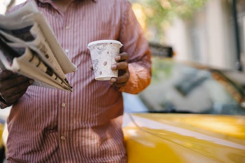 用外卖咖啡和报纸播种民族出租车司机 · 免费素材图片