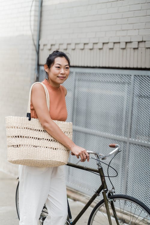 一个女人拿着她的自行车 · 免费素材图片