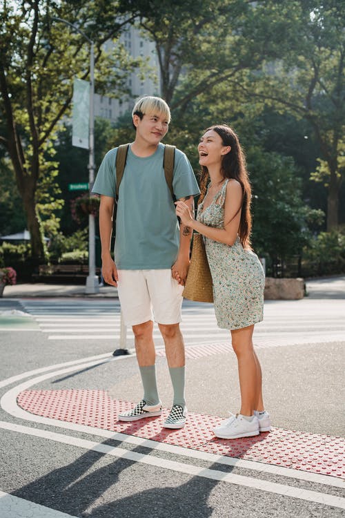 年轻人微笑多样夫妇站在人行横道上 · 免费素材图片