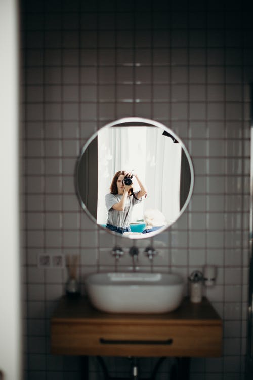选择性聚焦摄影的女人拍照反射在镜子上 · 免费素材图片