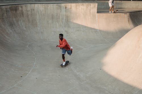 黑人滑板练习坡道附近作物朋友的极限运动 · 免费素材图片