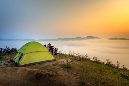 人们在露营帐篷附近俯瞰云海 · 免费素材图片