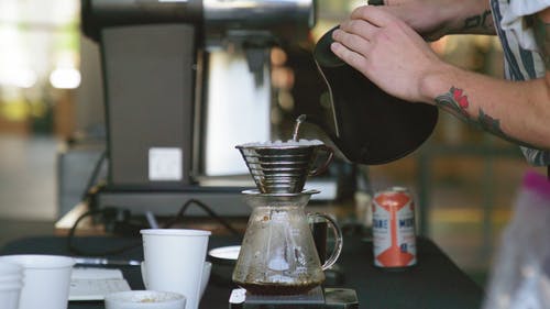 一个人在滴水冲泡的咖啡上倒热水的慢动作镜头 · 免费素材视频