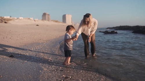 一位母亲和儿童在海滩玩 · 免费素材视频
